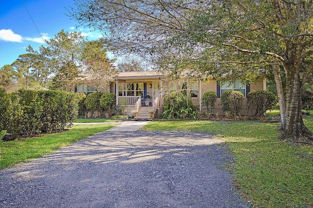 view of front of property with covered porch and a front yard