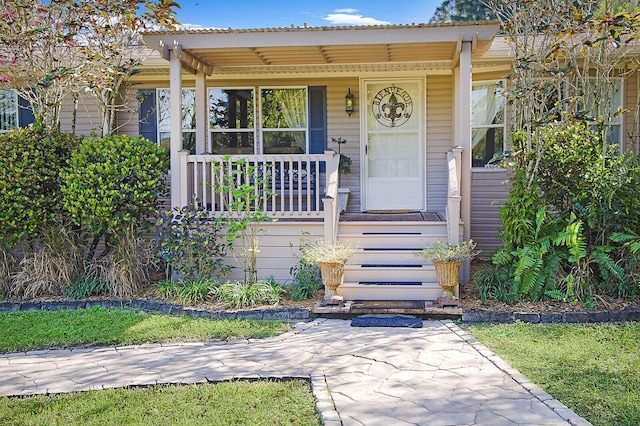 view of exterior entry with covered porch