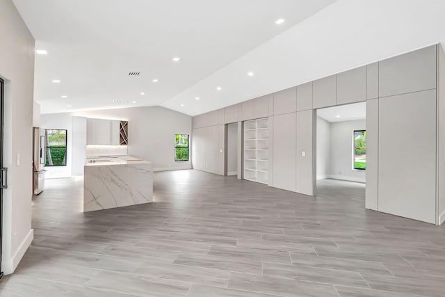 interior space featuring plenty of natural light and lofted ceiling