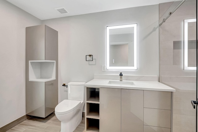 bathroom with toilet and vanity