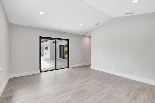 unfurnished room featuring vaulted ceiling