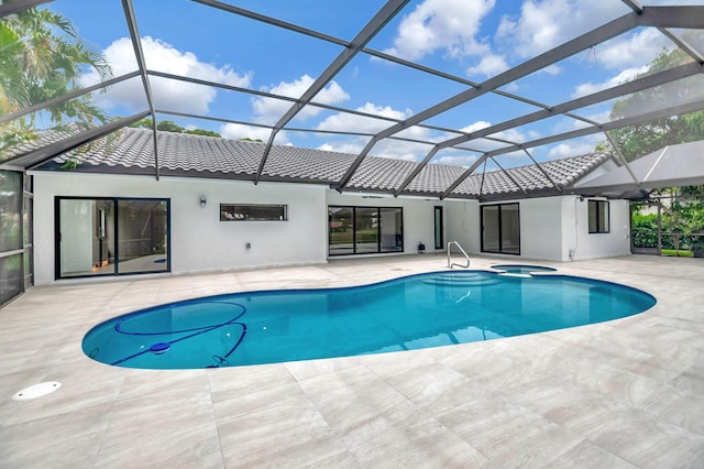 view of pool with an in ground hot tub, a lanai, and a patio area