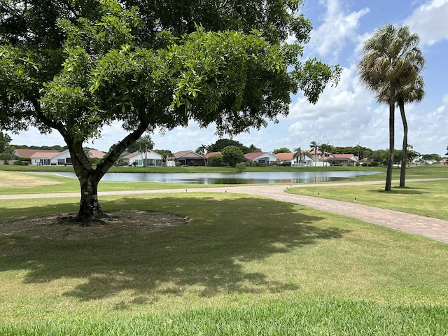 surrounding community featuring a water view and a yard