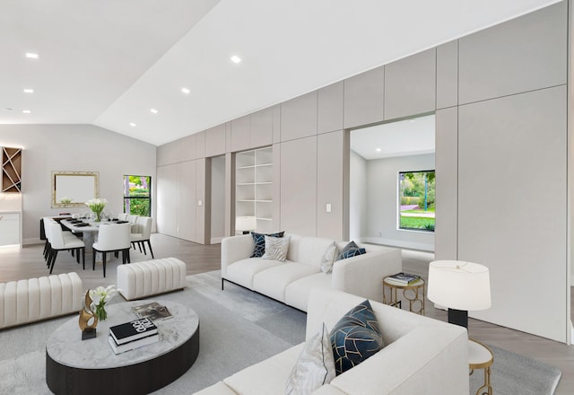 living room featuring hardwood / wood-style flooring and lofted ceiling