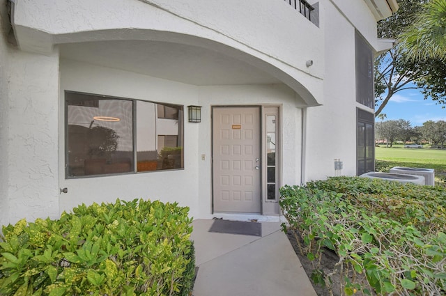 entrance to property featuring central air condition unit