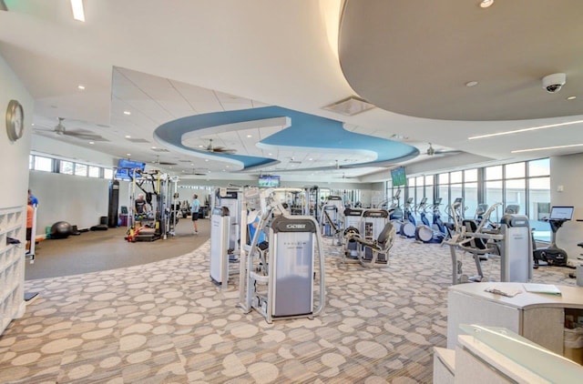 workout area with ceiling fan and carpet flooring