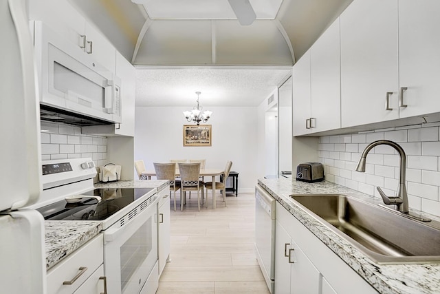 kitchen featuring white cabinets, decorative backsplash, sink, and white appliances