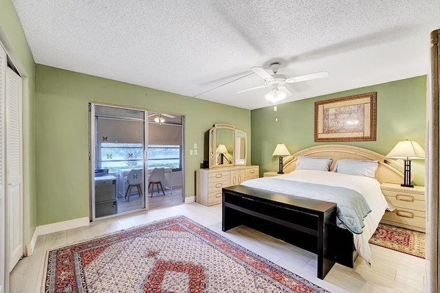 bedroom featuring ceiling fan, access to exterior, a textured ceiling, and a closet