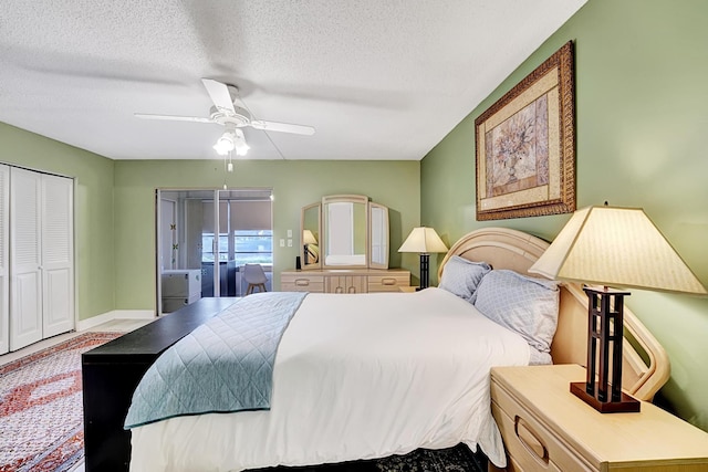 bedroom with a textured ceiling, ceiling fan, and a closet