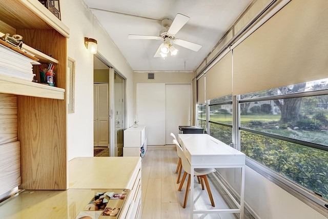 sunroom featuring ceiling fan