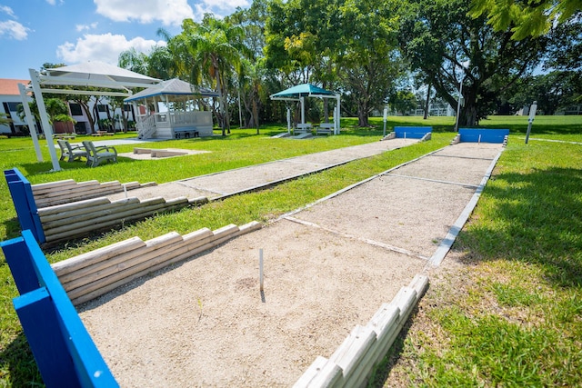 view of property's community with a gazebo and a lawn