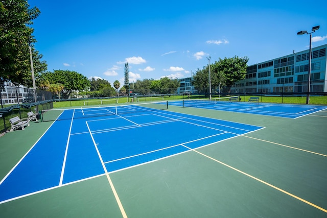 view of tennis court with basketball hoop