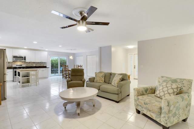 living room featuring ceiling fan and light tile patterned flooring