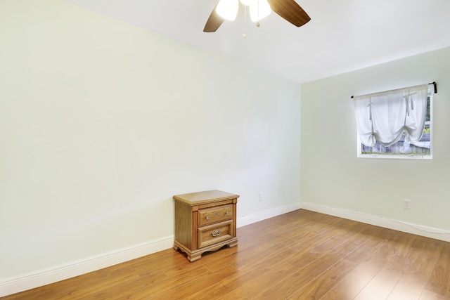 empty room featuring ceiling fan and light hardwood / wood-style flooring