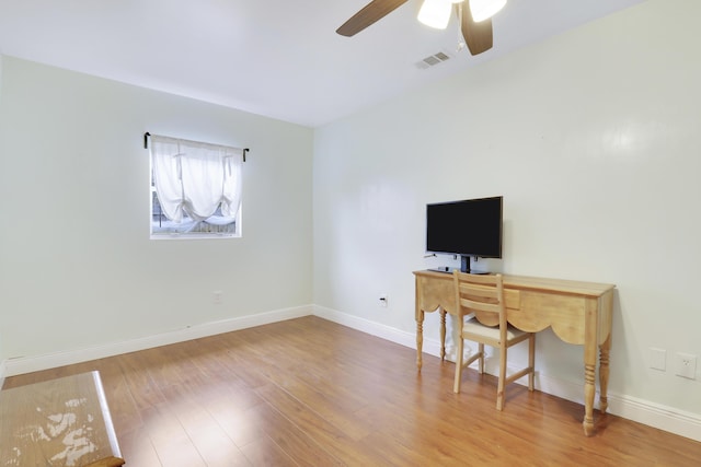 office space featuring wood-type flooring and ceiling fan