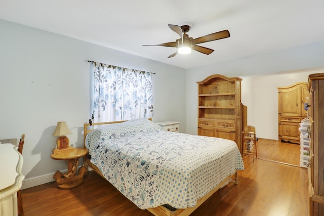 bedroom with hardwood / wood-style flooring and ceiling fan