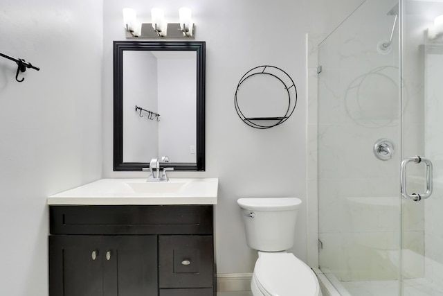 bathroom with walk in shower, vanity, and toilet