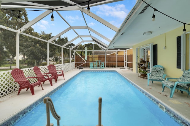 view of swimming pool with a lanai and a patio