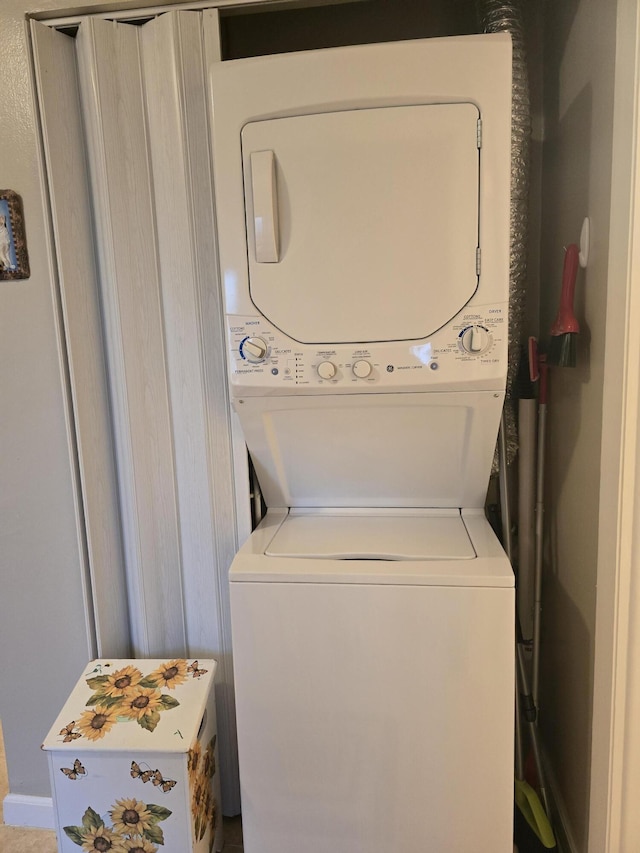 laundry room with stacked washer / drying machine