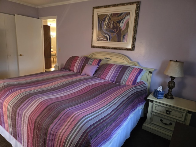 bedroom with ensuite bathroom and crown molding