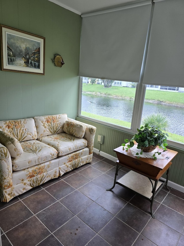 sunroom / solarium featuring a water view and plenty of natural light