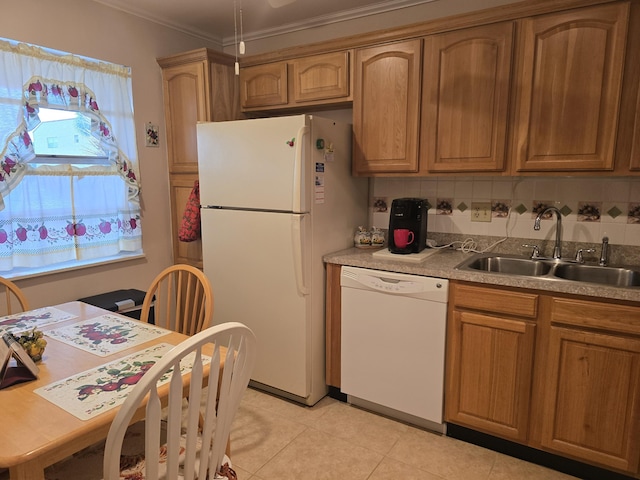 kitchen with light tile patterned floors, plenty of natural light, white appliances, crown molding, and sink