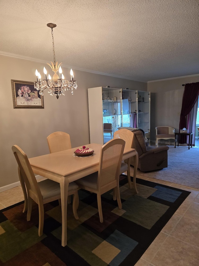 dining area with a chandelier, tile patterned floors, ornamental molding, and a textured ceiling