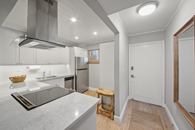 kitchen featuring white cabinetry, stainless steel appliances, sink, backsplash, and island range hood