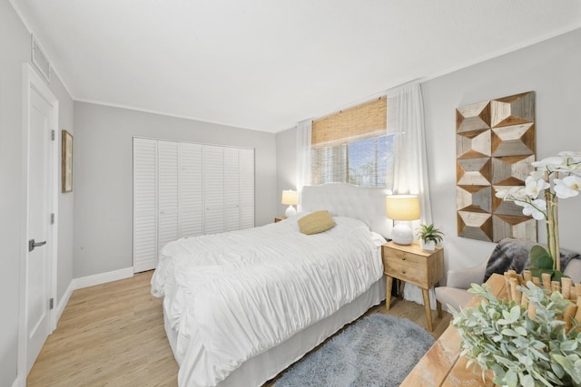 bedroom with a closet and light hardwood / wood-style flooring