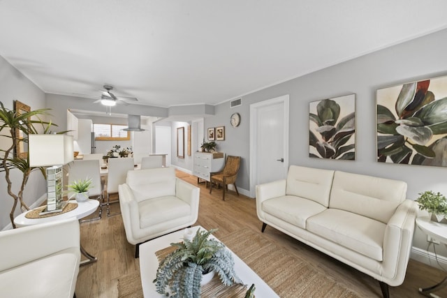 living room with hardwood / wood-style flooring and ceiling fan