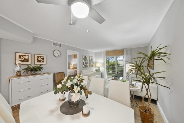 dining area with ceiling fan and light hardwood / wood-style flooring