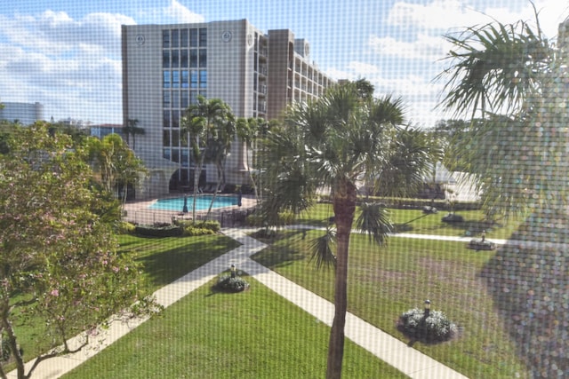 view of swimming pool with a lawn