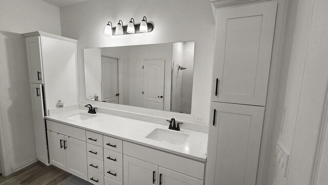 bathroom with vanity, a shower, and hardwood / wood-style flooring