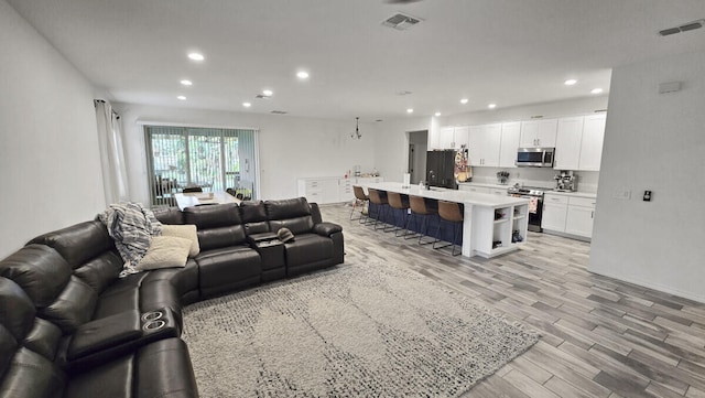 living room with light hardwood / wood-style floors