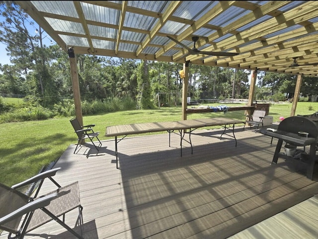 deck with a grill, a yard, and a pergola