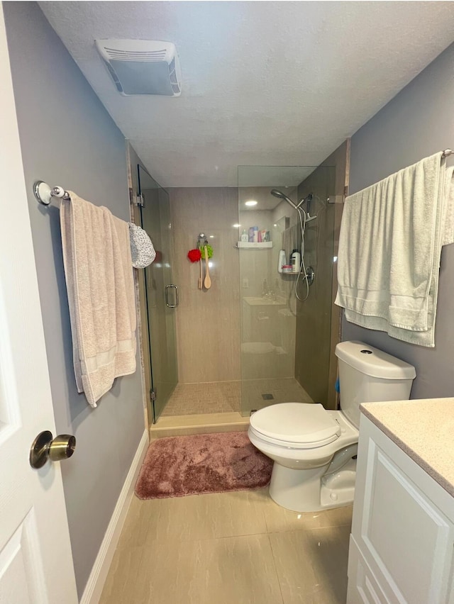 bathroom featuring an enclosed shower, vanity, and toilet