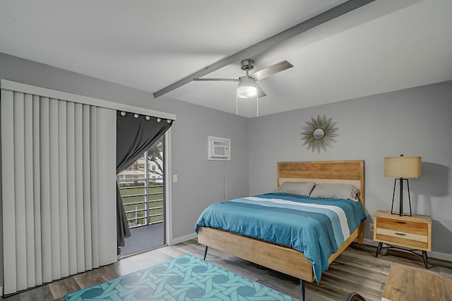 bedroom featuring access to exterior, wood-type flooring, a wall mounted AC, and ceiling fan