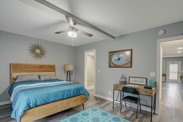 bedroom with hardwood / wood-style flooring, ceiling fan, connected bathroom, and beamed ceiling