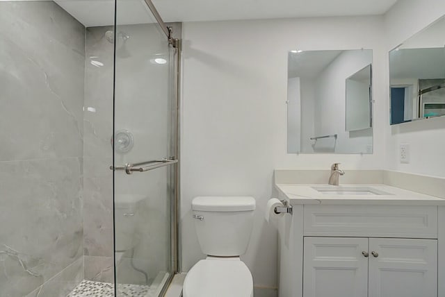 bathroom with vanity, toilet, and walk in shower