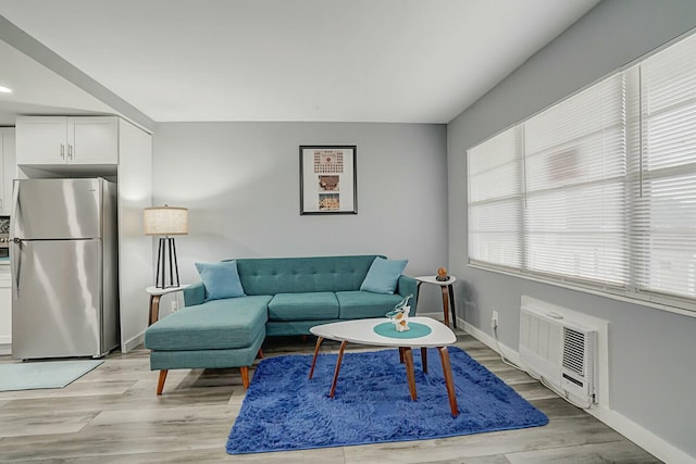 living room featuring an AC wall unit and light wood-type flooring