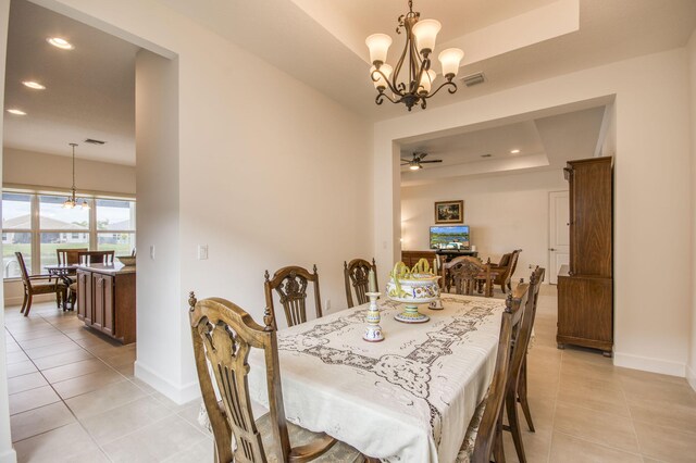 kitchen featuring stainless steel appliances, backsplash, a notable chandelier, light stone counters, and a center island