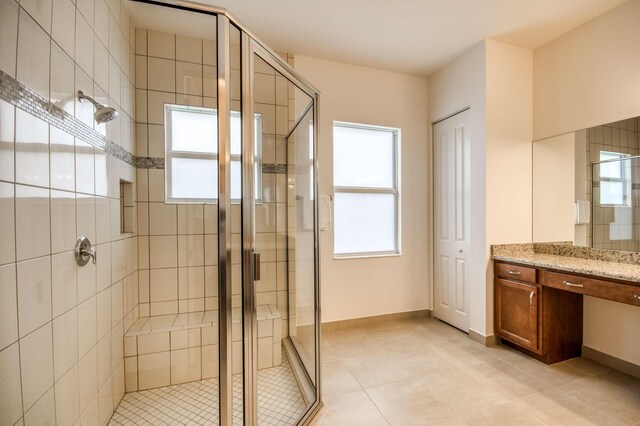 bathroom with vanity, tile patterned flooring, and walk in shower