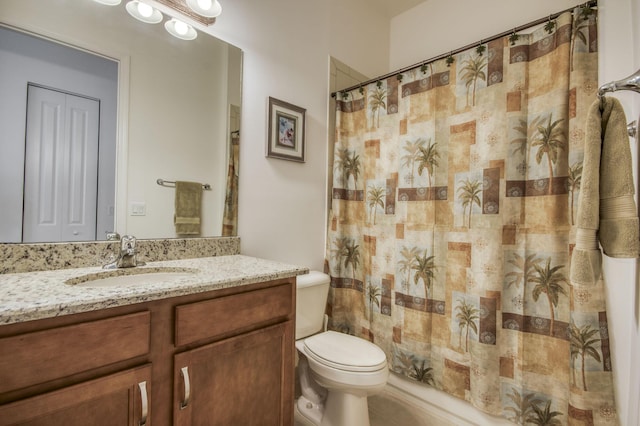 bathroom featuring toilet, vanity, and a shower with curtain