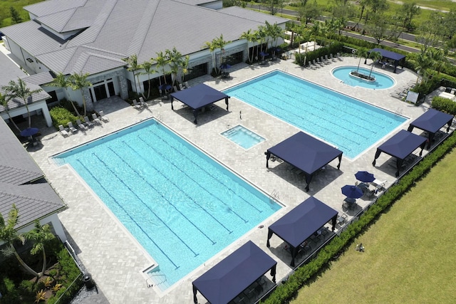 view of pool featuring a patio area and a hot tub