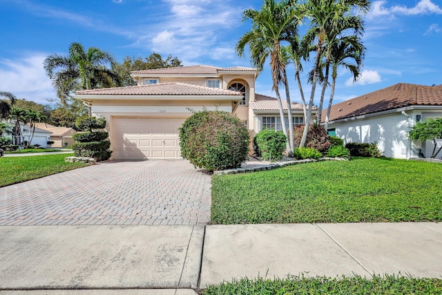 mediterranean / spanish home with a garage and a front yard