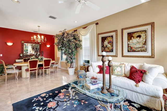 living room featuring ceiling fan with notable chandelier