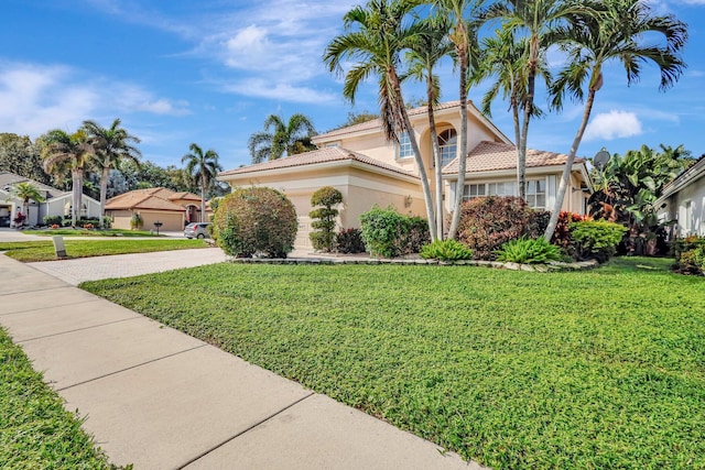 view of front of home featuring a garage and a front yard