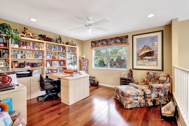 home office featuring ceiling fan, hardwood / wood-style flooring, and a textured ceiling