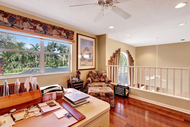 office area featuring hardwood / wood-style flooring, ceiling fan, and a textured ceiling