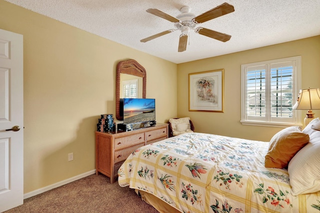 carpeted bedroom with ceiling fan and a textured ceiling